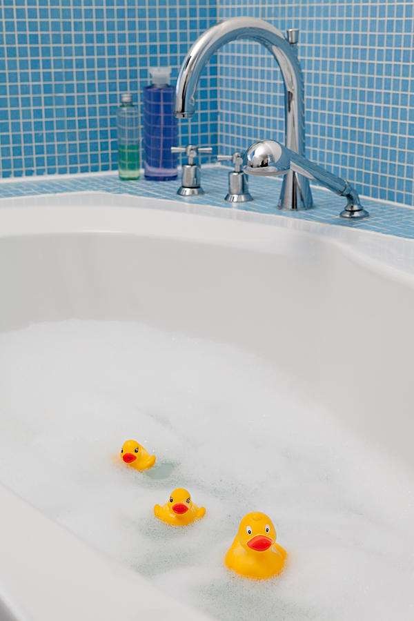 Rubber ducks in bath Photograph by Image Source