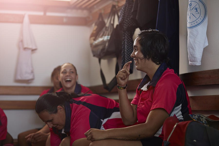 Rugby players laughing together in changing room Photograph by Klaus Vedfelt