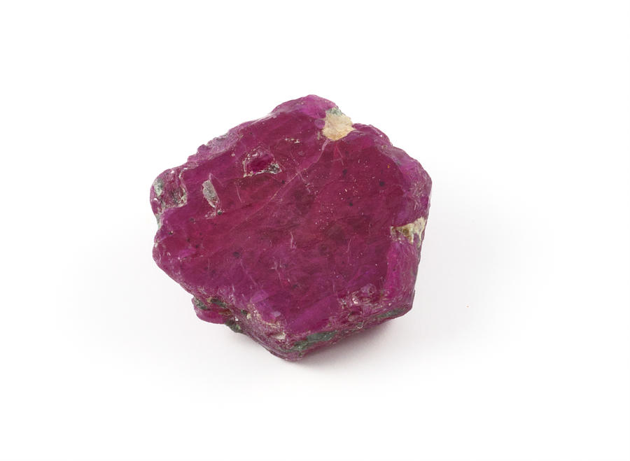 Rugged ruby gem stone on a white background Photograph by Kerrick
