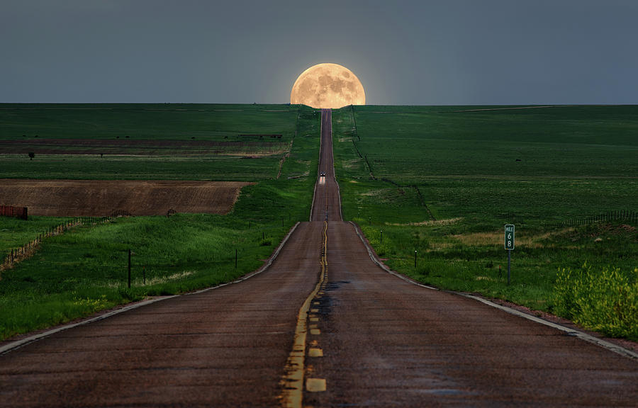 Running from the Moon - equinox moonrise over hwy 94 near Karval Colorado Photograph by Peter Herman