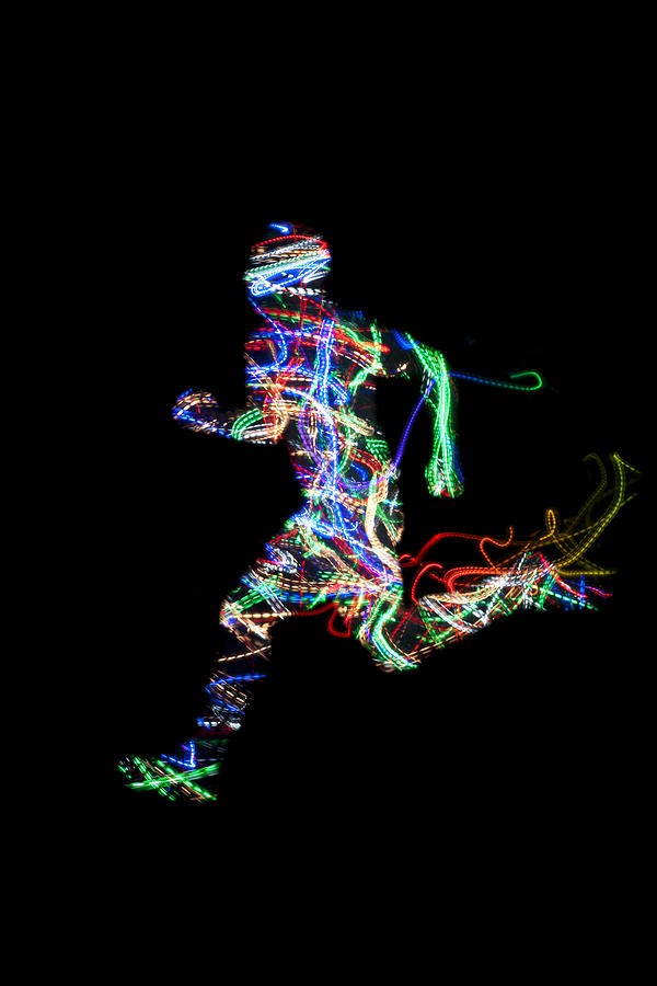 Running man with light trail texture on black Photograph by Colormos