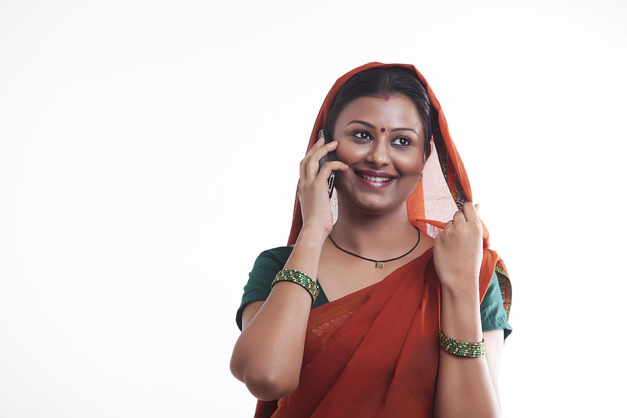 Rural woman talking on mobile phone Photograph by Hemant Mehta
