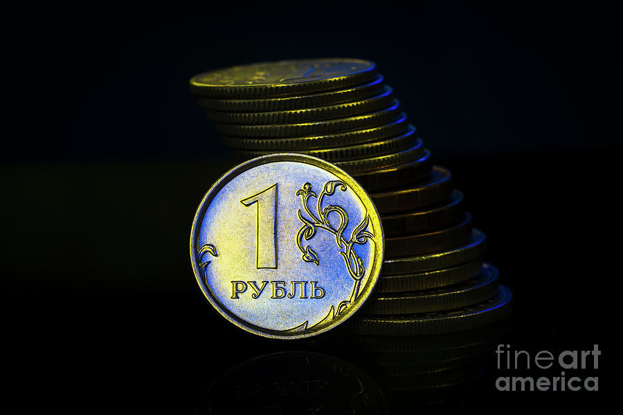 Russian Ruble Coins with falling Stack. Ukrainian flag colors illuminating. Ukraine war sanctions exchange rate ruble fall concept. Macro Photograph by Pablo Avanzini