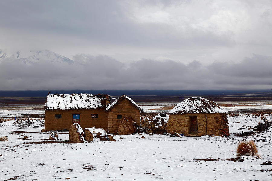 Rustic houses in the snow Sajama National Park Bolivia Photograph by James Brunker