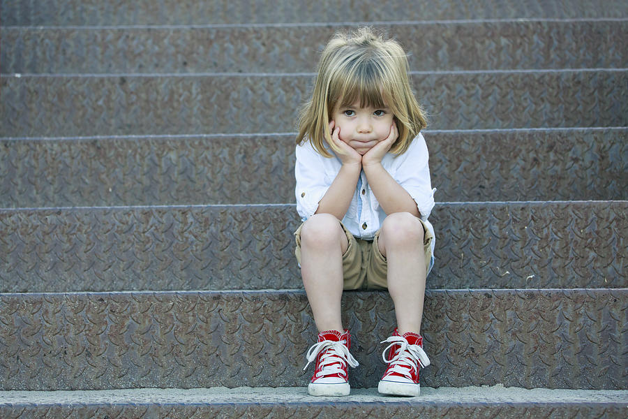 Sad boy sitting on staircase Photograph by Portishead1