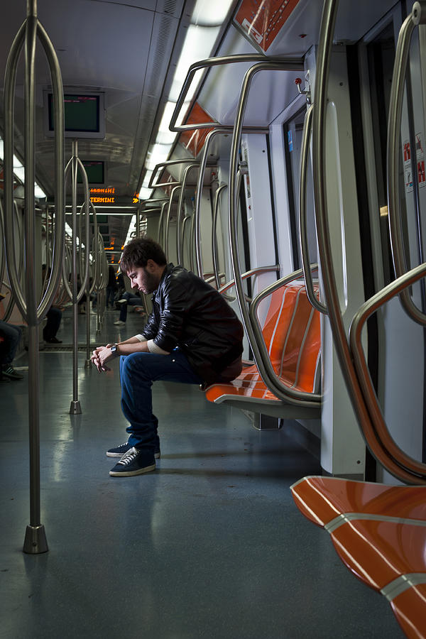 Sad looking guy in the subway Photograph by Nicola Bernardi Photography