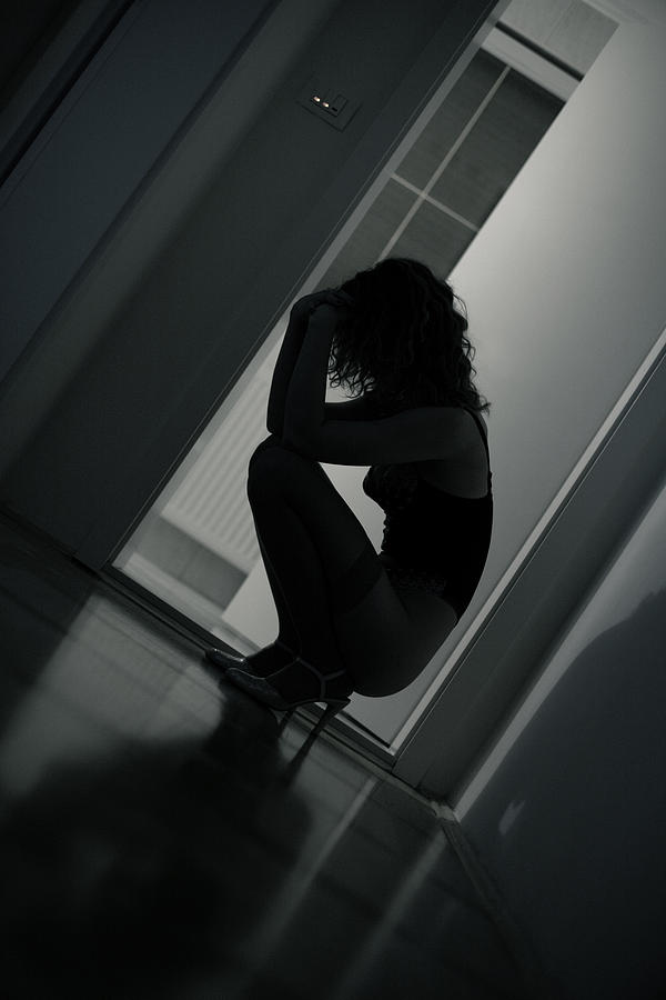 Sad Young Woman Kneeling on Floor, Low Key Photograph by Gremlin