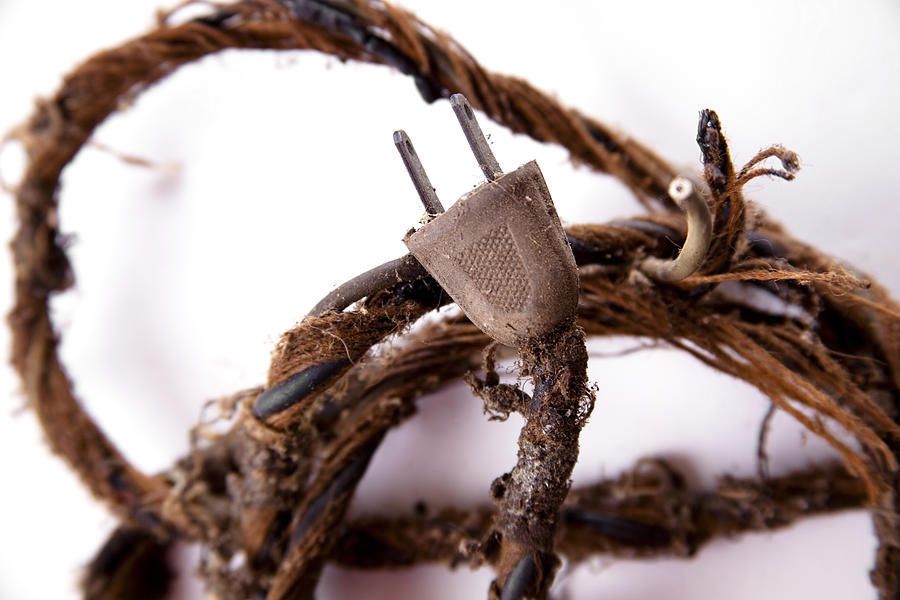 Safety.  Frayed old electrical cord, plug. Safety hazard. Photograph by Fstop123