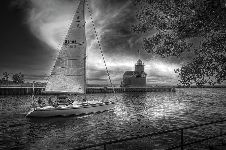 Sailboat at the Holland Harbor Lighthouse in Black and White Photograph by Debra and Dave Vanderlaan