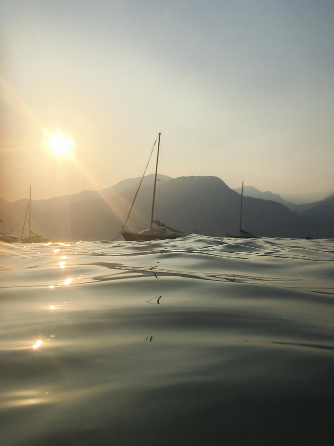 Sailboat on Lake Garda at sunset, Italy Photograph by Larissa Veronesi