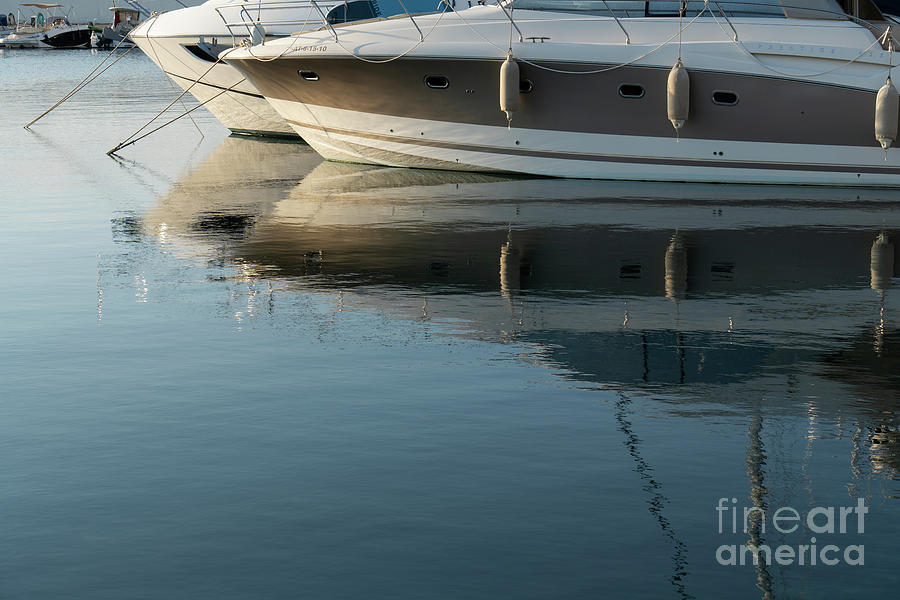 Boats are reflected in calm sea water 1. Mediterranean coast Photograph by Adriana Mueller