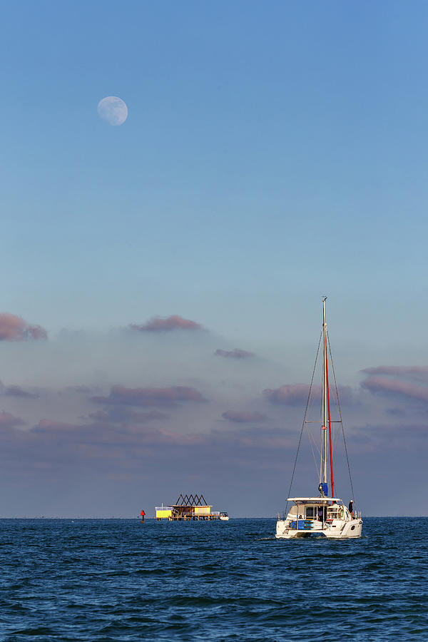 Sailboat, Stilthouse And The Moon Photograph