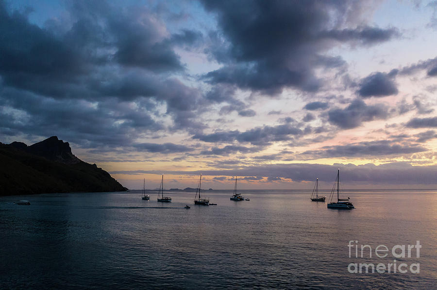 Sailboats anchored for the night by an island in the Yasawa grou Photograph by Didier Marti