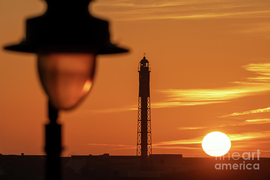 Saint Sebastian Lighthouse Silhouetted against Dramatic Orange Red Sky at Sunset La Caleta Cadiz Photograph by Pablo Avanzini