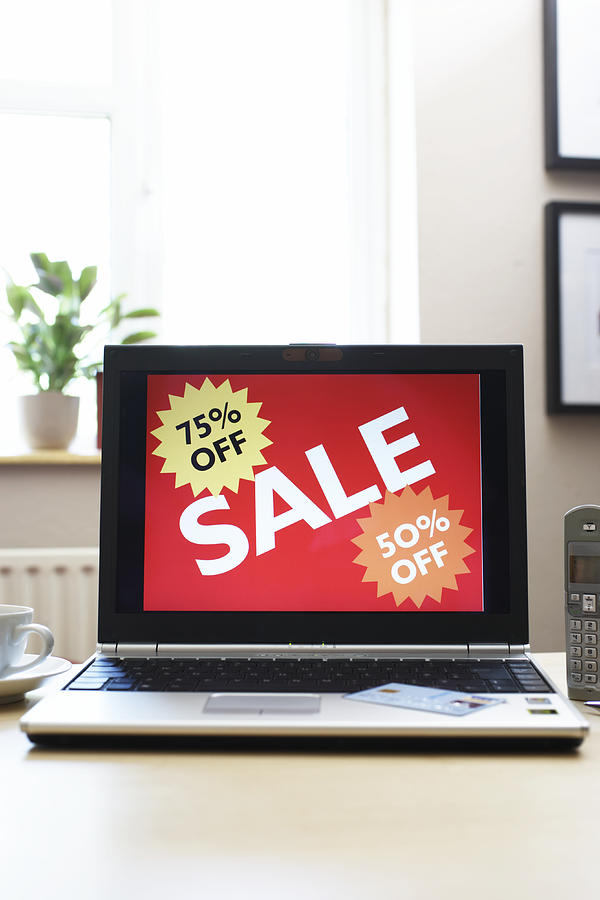 Sale advertisment on screen of laptop Photograph by Martin Poole