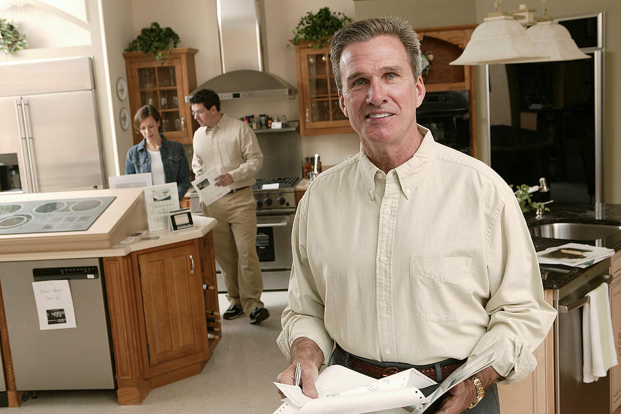 Salesman in home improvement store Photograph by Comstock Images