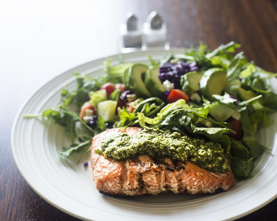 Salmon fillet topped with arugula pesto and salad Photograph by Image by Sherry Galey