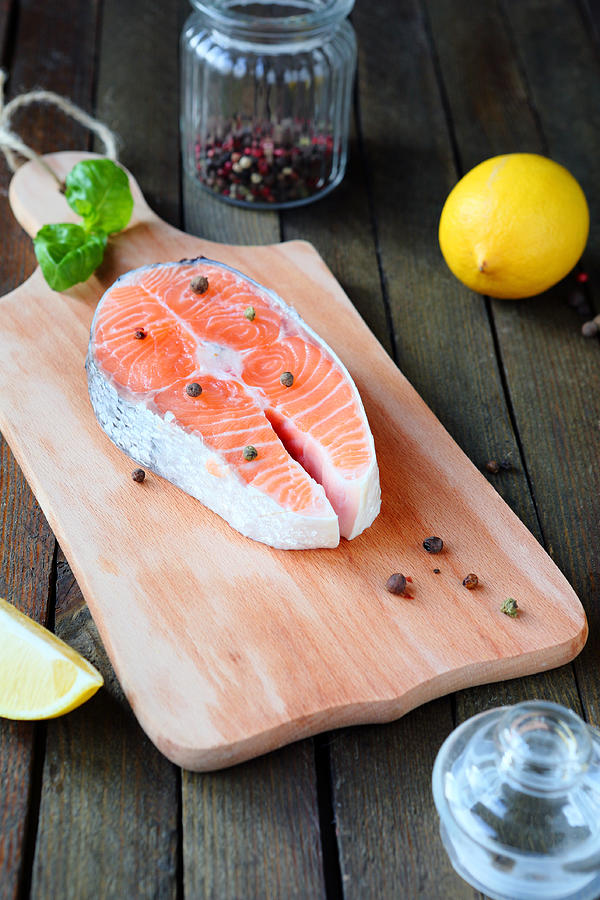 Salmon steak on a cutting board Photograph by Olha_Afanasieva