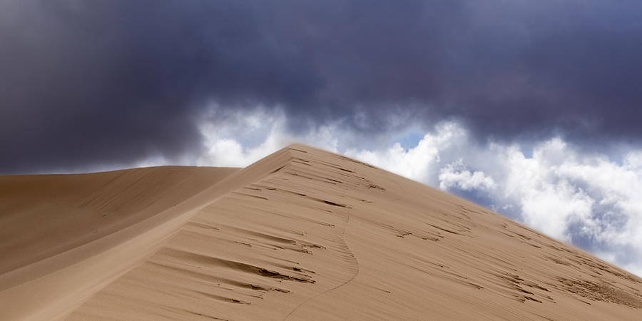 Sand dunes in a desert Photograph by Fotosearch