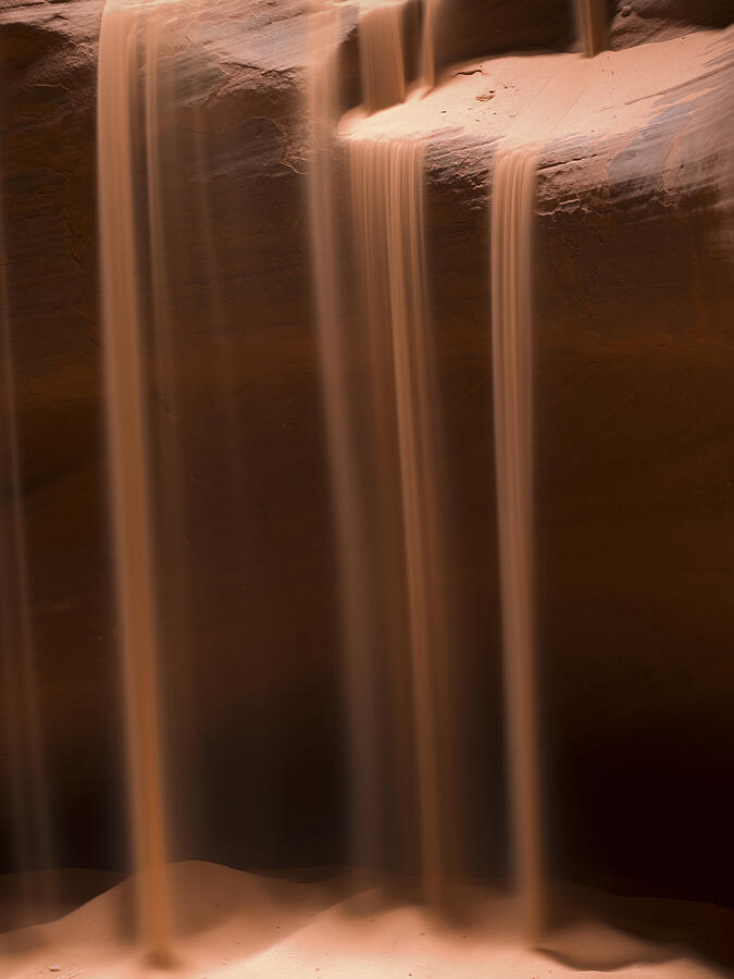Sand falling in a slot canyon Photograph by Fotosearch