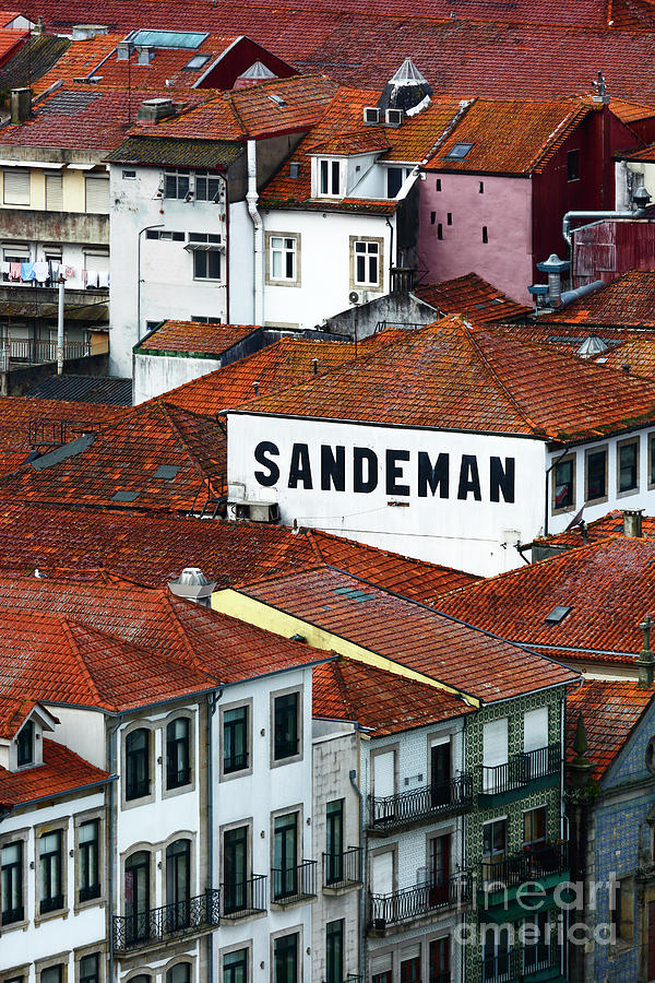 Wine Photograph - Sandeman port warehouse and tiled roofs Portugal by James Brunker