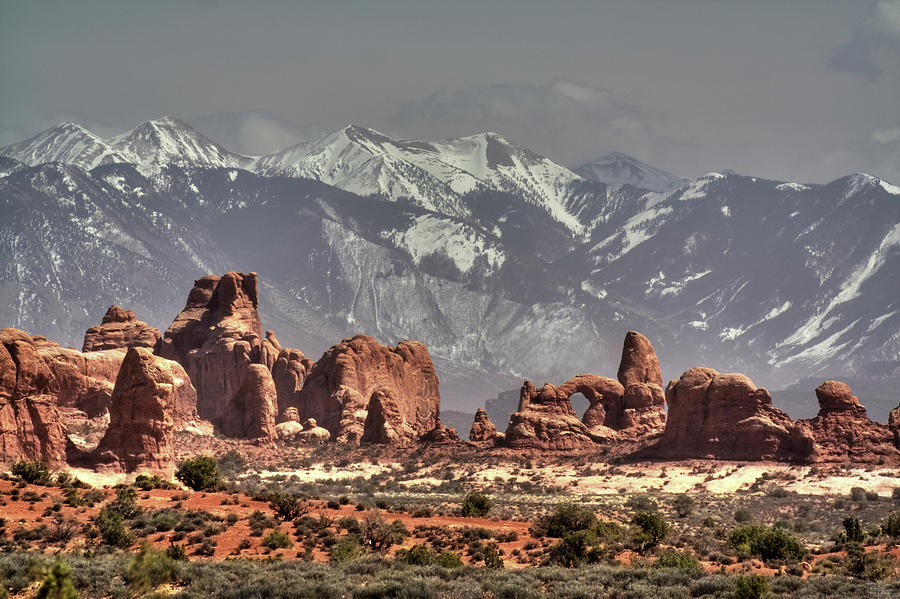 Sandstone formations and Turret Arch vista in Arches National Park with La Sal mountains behind Photograph by Peter Herman