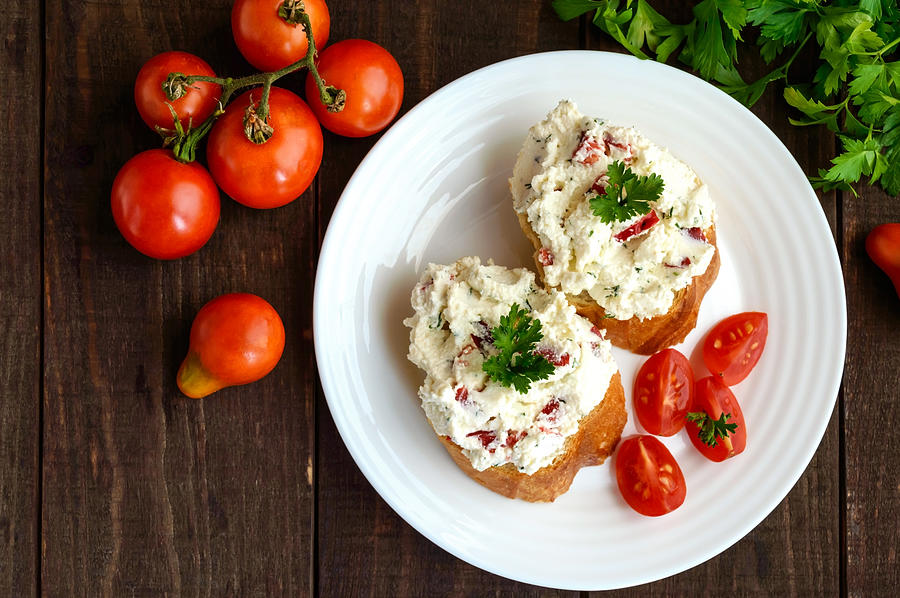 Sandwiches with pate cheese, garlic, slices of pepper, dill. Photograph by Maryna Iaroshenko