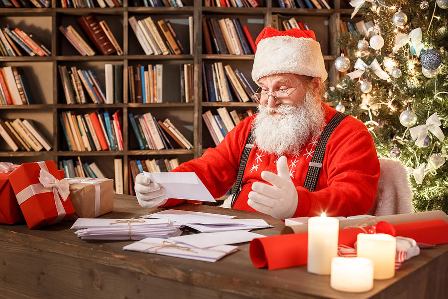 Santa Claus in the library christmas new year concept Photograph by Sergii Gnatiuk