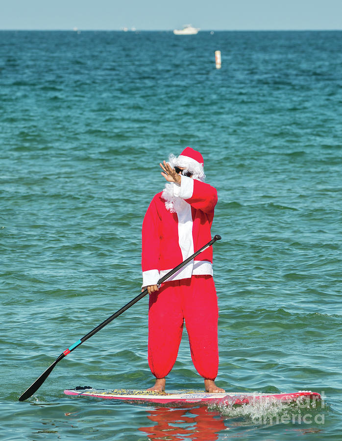 Santa Claus paddling Photograph by Les Palenik