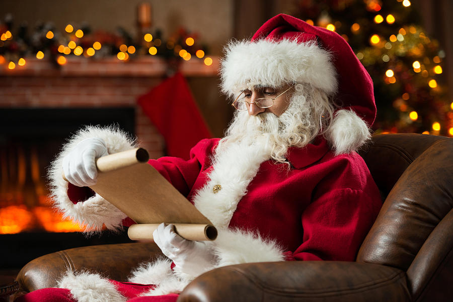 Santa Claus reading a list. Photograph by Skynesher