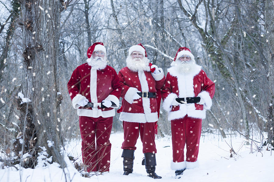 Santas at forest delivering presents Photograph by Vesnaandjic
