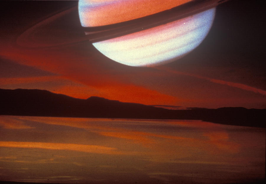 Saturn superimposed on a cloudy sunset sky Photograph by Fotosearch