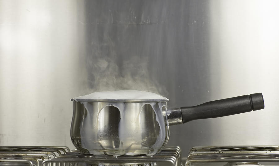 Saucepan Of Boiling Milk Photograph by Vandervelden