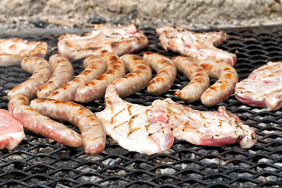 Sausages and pork chops barbecued Photograph by Jean-Marc PAYET