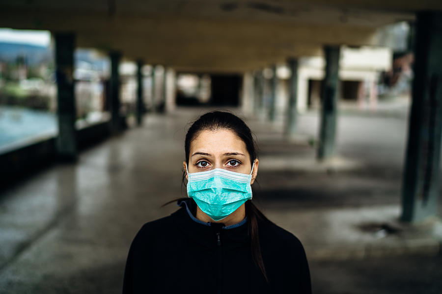 Scared sick woman wearing protective mask.Suffering from infectious disease.Infected patient suffering from symptoms of illness.Panic and fear of infection.Life in contaminated area.Nosophobia Photograph by Conceptual,fashion,advertising