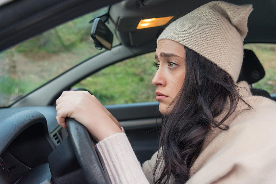 Scared woman driver in car. Inexperienced anxious motorist Photograph by Stock-eye