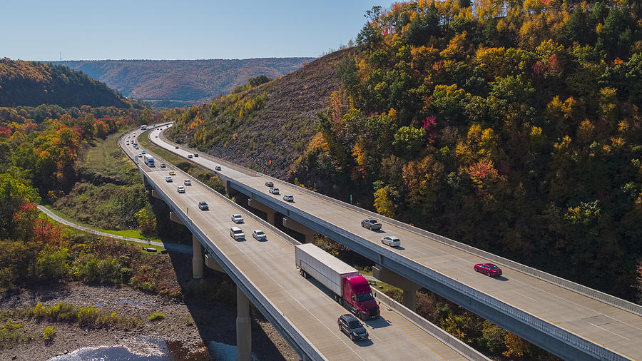 Scenic aerial view of the high bridge at the Pennsylvania Turnpike lying between mountains in Appalachian on a sunny day in fall. Photograph by Alex Potemkin