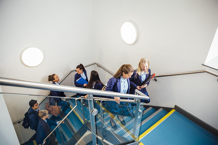 School Children Walking up School Staircase Photograph by SolStock