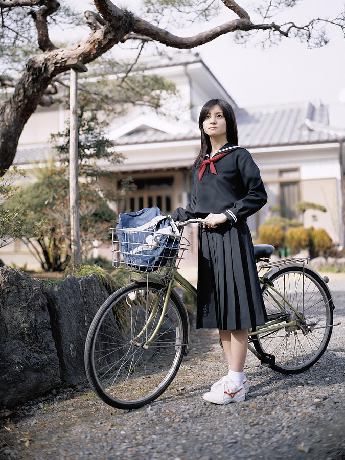 School girl holding a bicycle Photograph by Dex Image