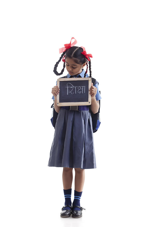 School girl holding slate Photograph by IndiaPix/IndiaPicture