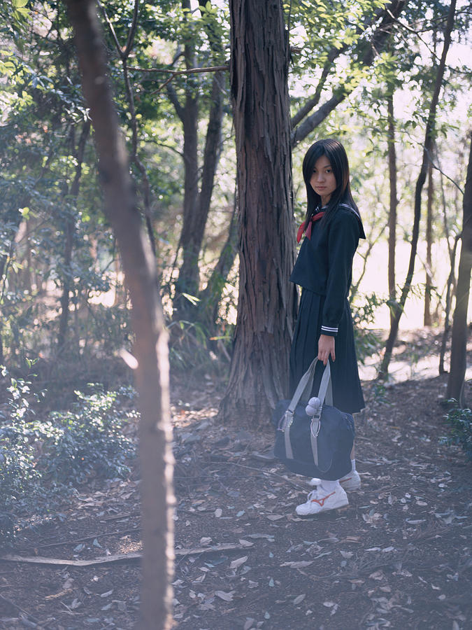School girl standing in a park Photograph by Dex Image