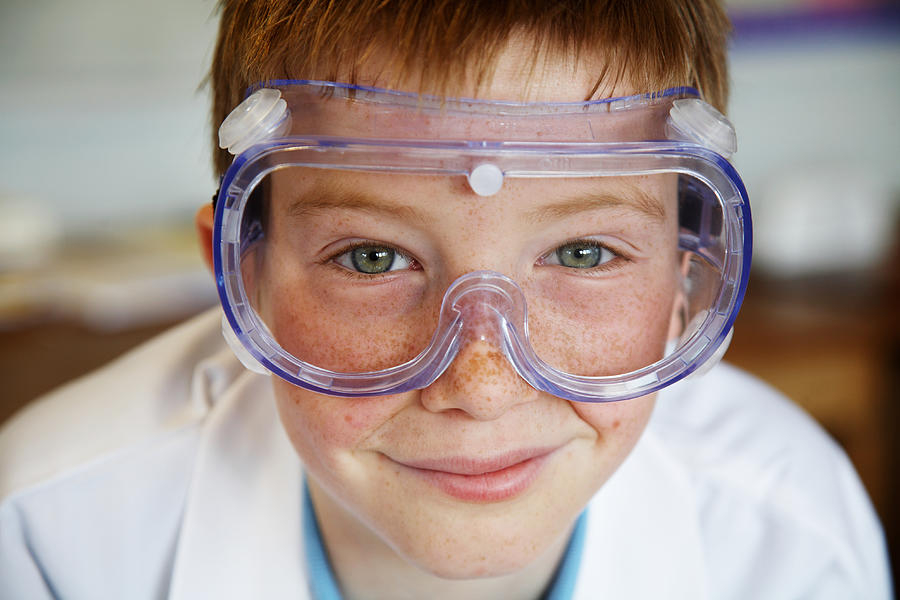 Schoolboy (11-13) wearing protective goggles, smiling, portrait Photograph by Ableimages