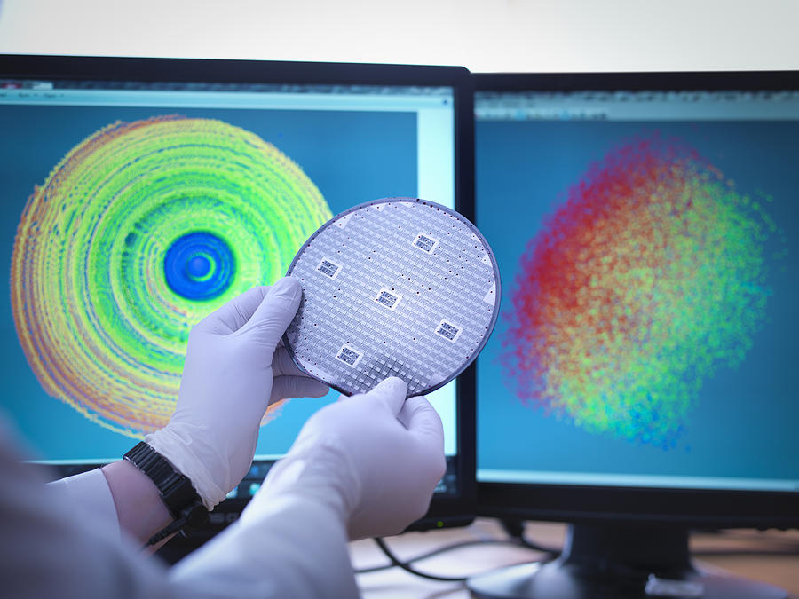Scientist checking test map of silicon wafer in laboratory, close up Photograph by Monty Rakusen