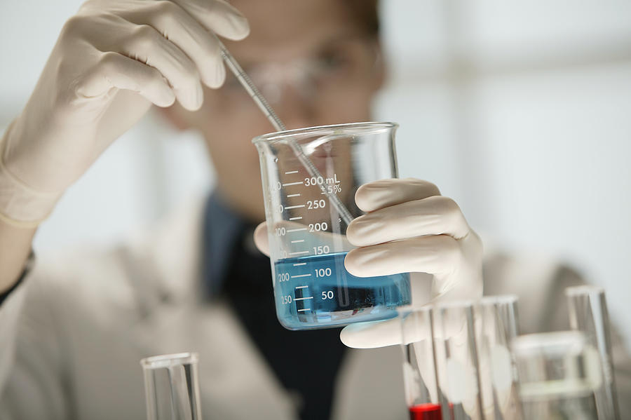 Scientist working in laboratory Photograph by Comstock Images