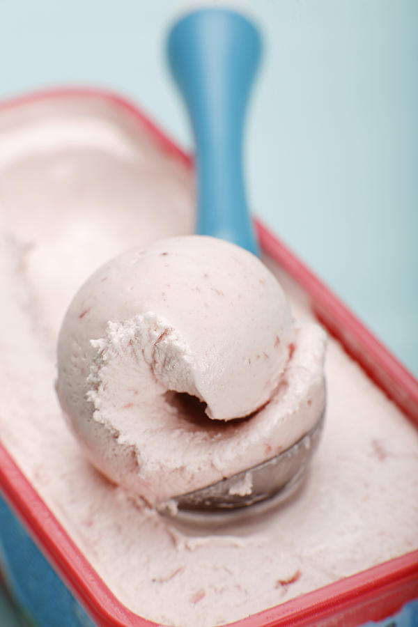 Scoop of strawberry ice cream on ice cream scoop, close-up Photograph by Chris Schuster