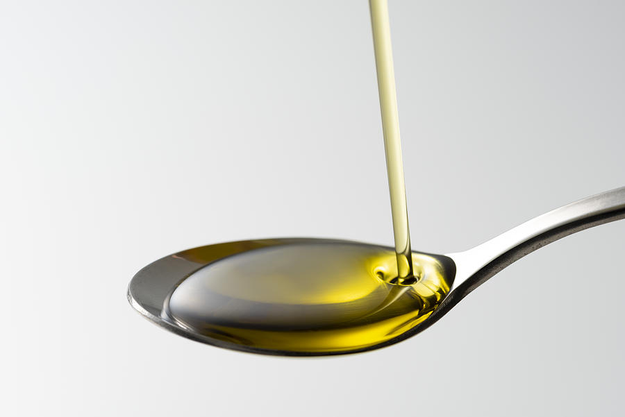 Scoop olive oil with a spoon Photograph by Kuppa_rock