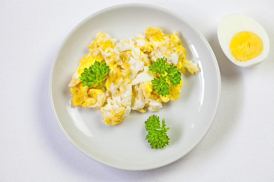Scrambled eggs On white plate and hard-boiled egg Photograph by Mikroman6