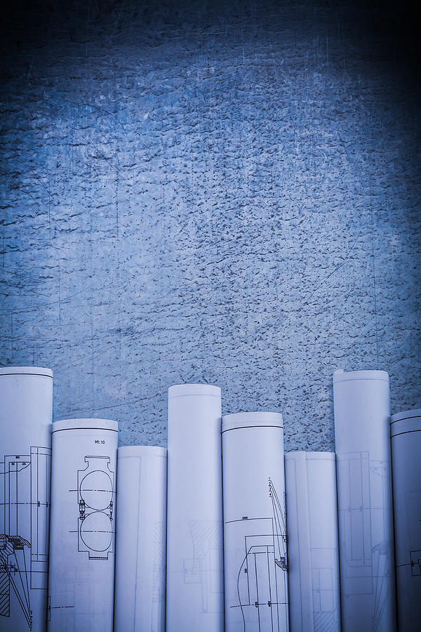 Scratched metallic surface with blueprint rolls construction con Photograph by Mihalec