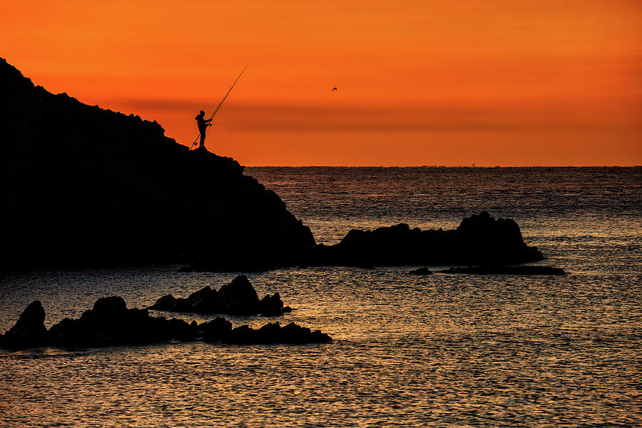 Sea Sunrise With Lone Angler On Rock Photograph by Artur Bogacki