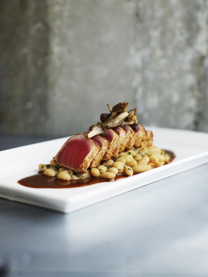 Seared spiced tuna with cannellini beans Photograph by Thomas Barwick